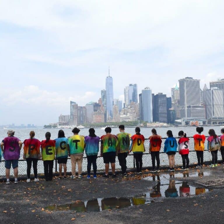 Children with shirts spelling respect and justice