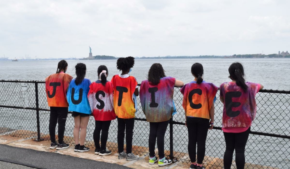 children with shirts spelling "Justice"